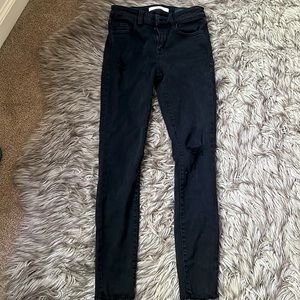 Distressed stretchy black jeans